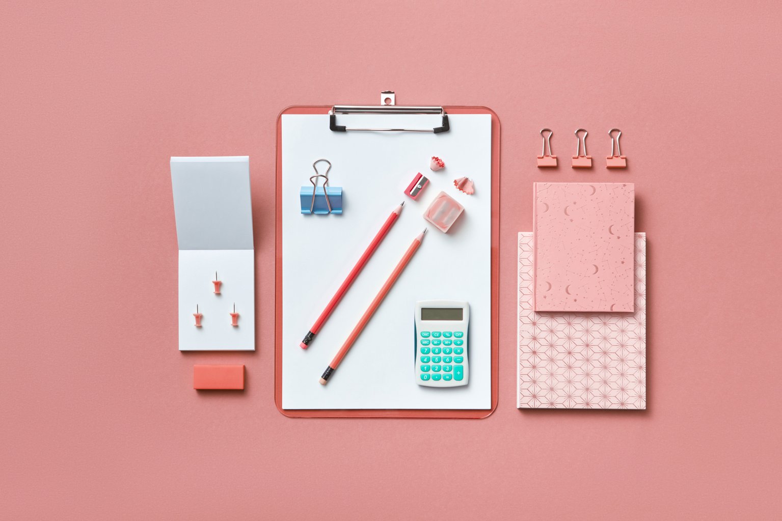 School and Office Supplies on a Pink Surface